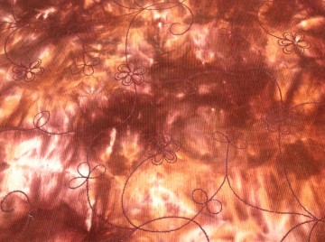 Mooie ribcorn in tinten oranje/bruin, tye and dye met borduursels, voor bv broek, rokje, jasje, overgooier of buitenkant van een winterjas