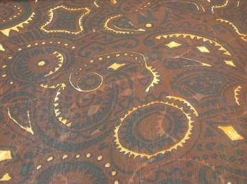 Voile met fantasiemotief in tinten bruin en donkergeel, iets doorzichtig. Mooi voor wijde blouse, tuniek, shawl of bovenlaag van een rokje