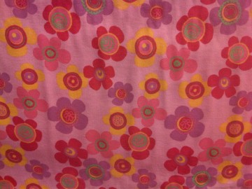 Kleurige katoenen tricot met bloem in roze, koraal, lila enz